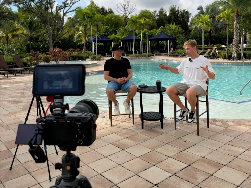Behind the scenes of an 8-Figure HVAC Brands Podcast recording by the pool in Fort Myers, Florida