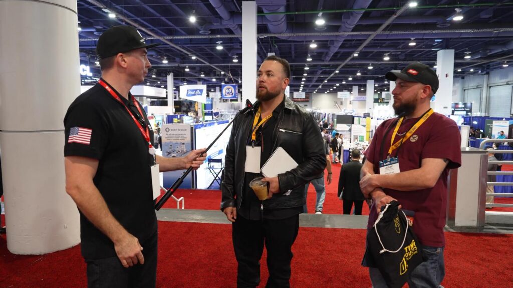 Daniel Dramshev talks with Randy Callan of Rescue One Air and Jesse Cock of Panther Air at AHR Expo